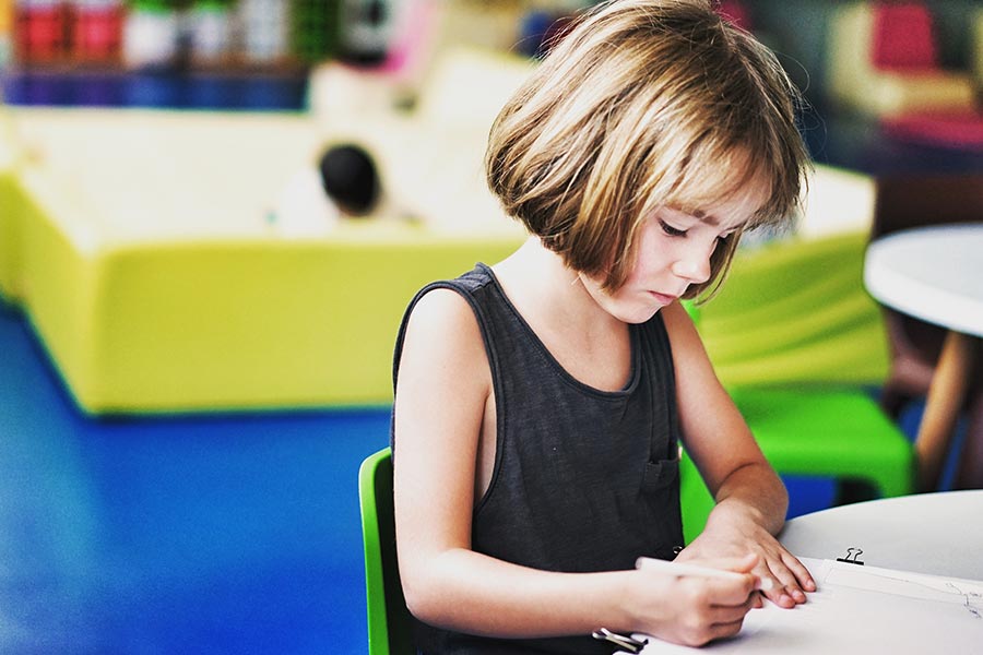 Girl drawing at desk